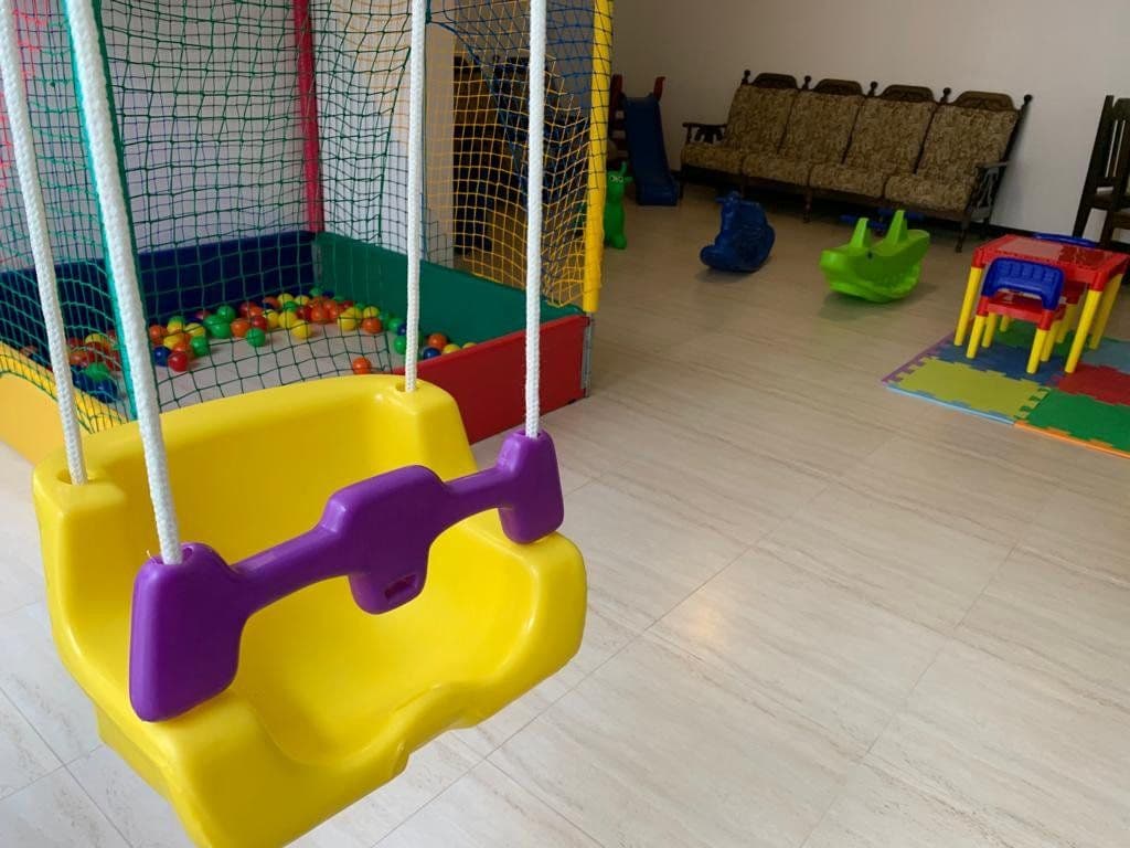 Espaço kids com piscina de bolinhas, balanço e brinquedos